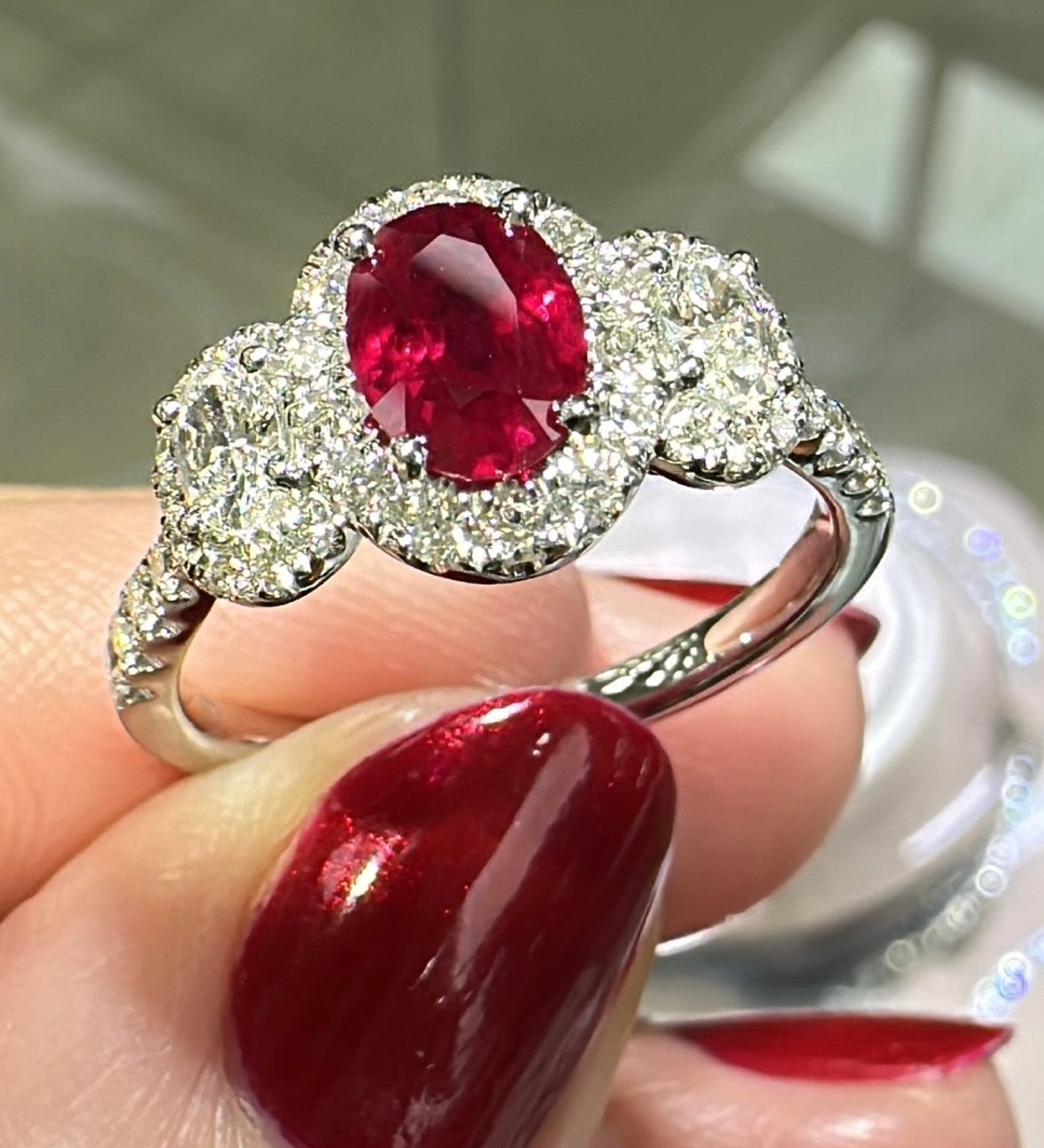 Three Stone Oval Ruby Center Halo Ring with Diamonds